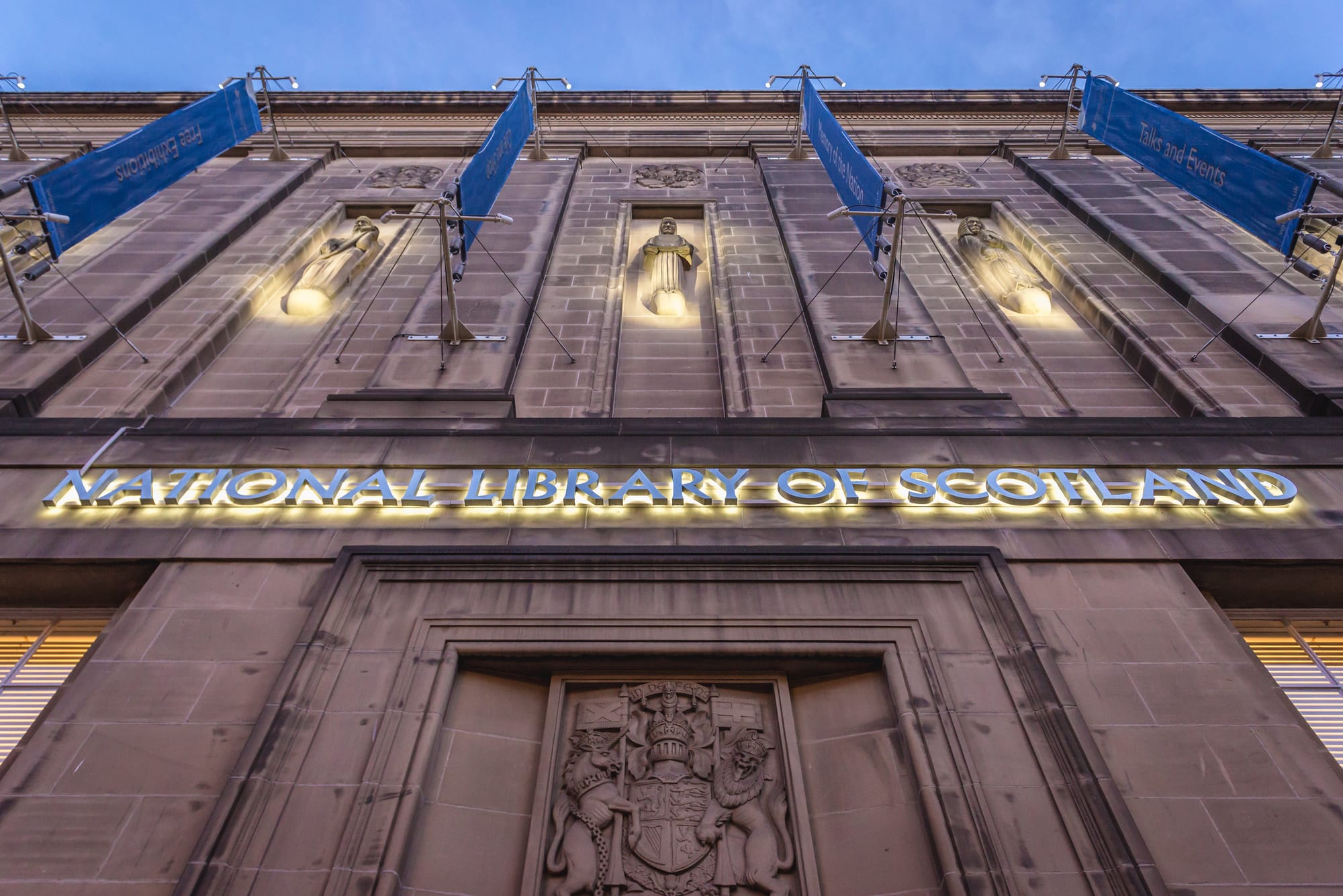 image of the front of the National Library of Scotland, looking up at the logo