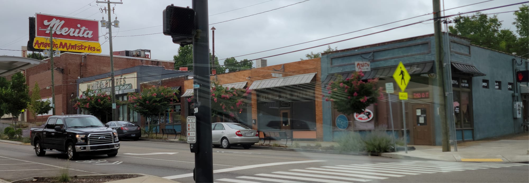 a streetfront view of a row of connected stores